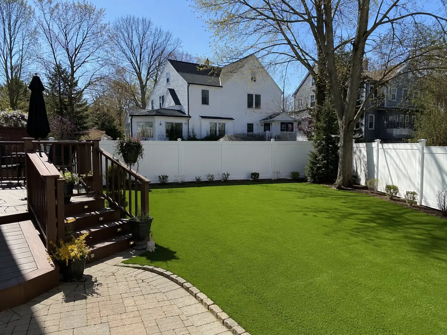 Completed residential backyard artificial turf installation at a New York home